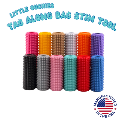 Little Ouchies Tag Along bag stim tool shown in all thirteen colors, a textured strap clip fidget made in the USA